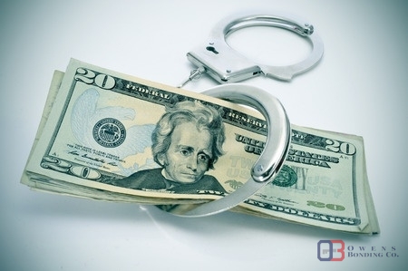 20 dollar bill with handcuffs around it. Concept of bail bonds and bail bondsman. Owens Bonding Rice County, Kansas. 