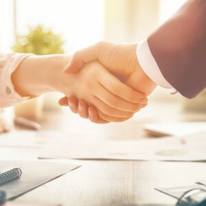 Man and woman are shaking hands in office. Collaborative teamwork.