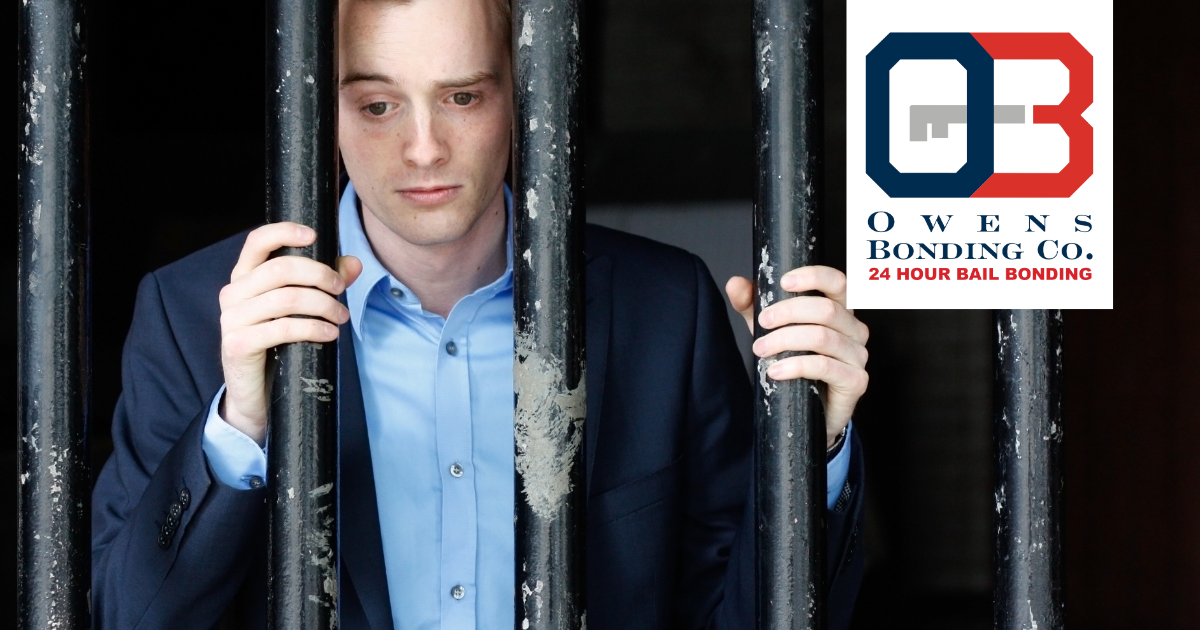 Owens Bonding Available in El Dorado, Kansas. Picture of man in suit behind bars with Owens Bonding Logo. 